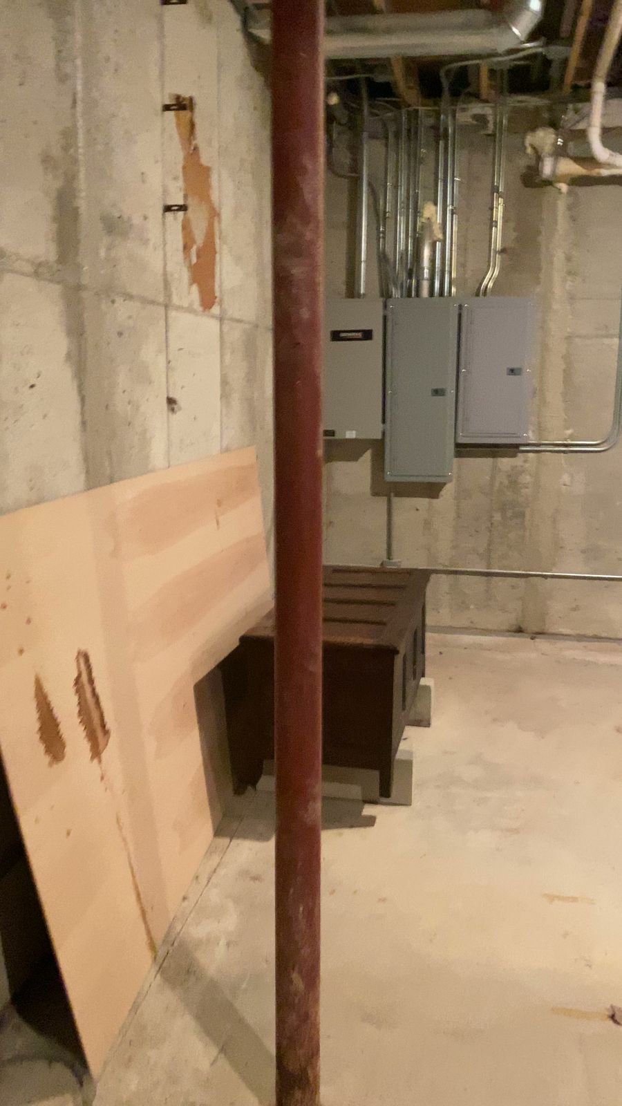 Bare concrete wall, steel post and exposed electrical before work started