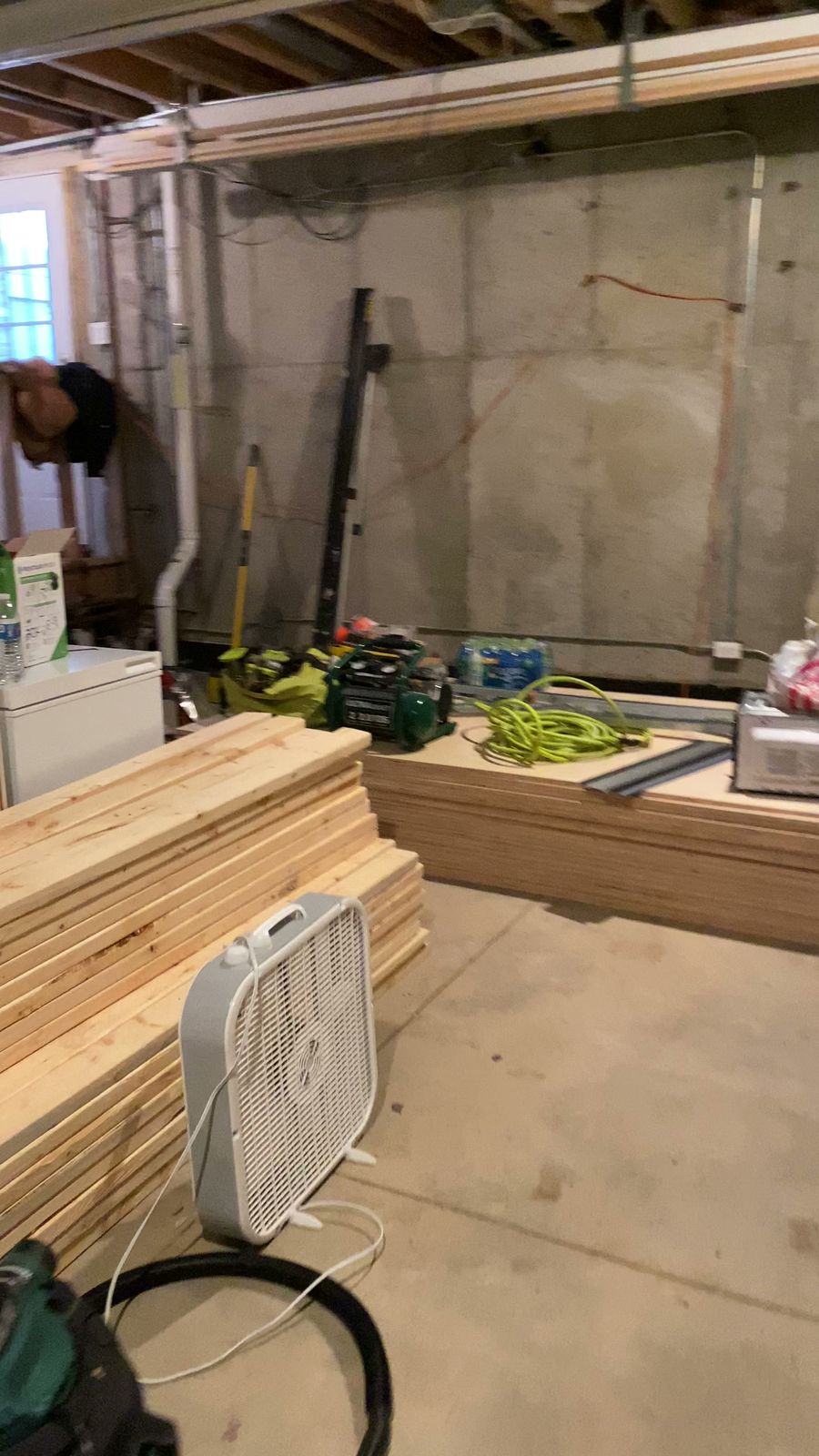 Unfinished basement with exposed framing and construction materials