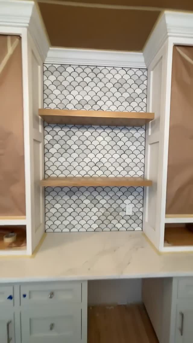 Fish-scale mosaic and floating shelves mid-installation