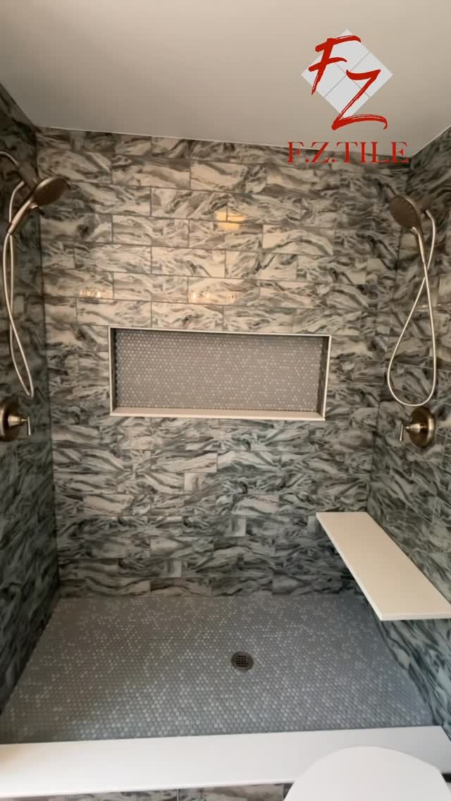 Stone mosaic walk-in shower with built-in bench